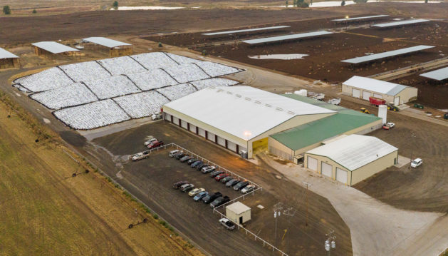 Aerial view of large dairy operation with feedlots, mixing barn and feed pile
